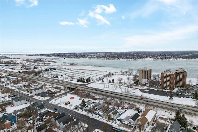 snowy aerial view with a water view