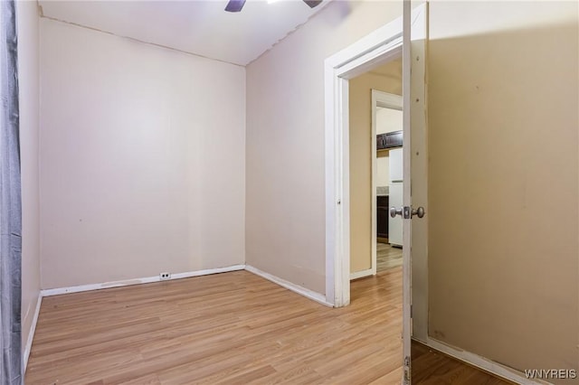 spare room with light hardwood / wood-style floors and ceiling fan