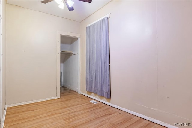 unfurnished bedroom with ceiling fan, a closet, and light hardwood / wood-style flooring