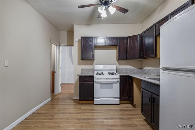 kitchen featuring ceiling fan, white appliances, dark brown cabinets, and light wood-type flooring