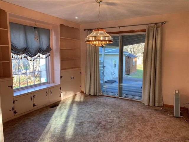 unfurnished dining area featuring carpet and a notable chandelier