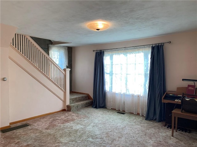 living room featuring carpet flooring and a textured ceiling