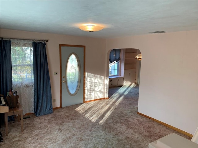 entrance foyer with carpet flooring