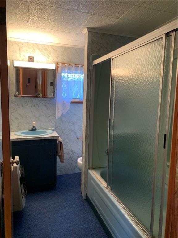 full bathroom featuring enclosed tub / shower combo, vanity, and toilet