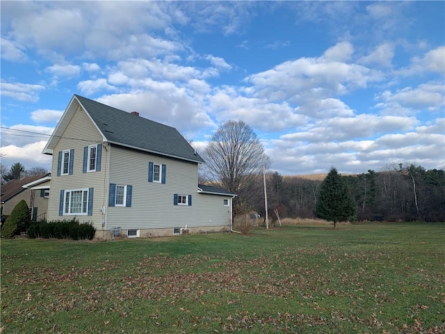 view of side of property featuring a yard