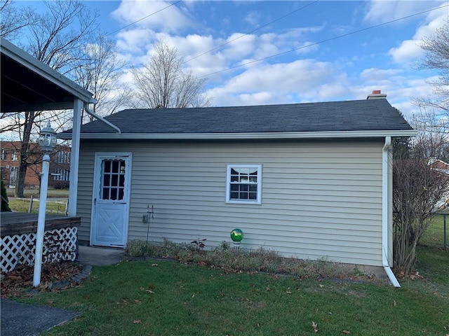 view of outbuilding featuring a lawn