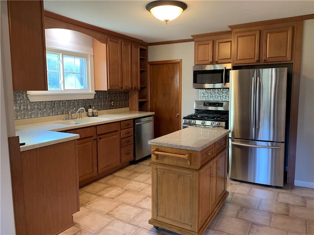 kitchen with sink, backsplash, a center island, stainless steel appliances, and crown molding