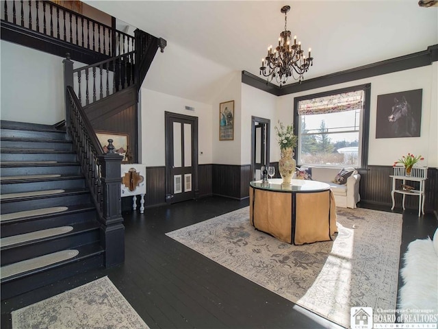 living room with dark hardwood / wood-style flooring and a chandelier