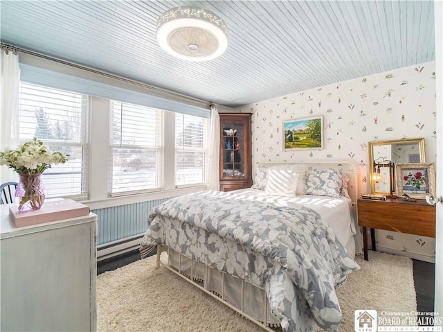 bedroom featuring carpet flooring and baseboard heating