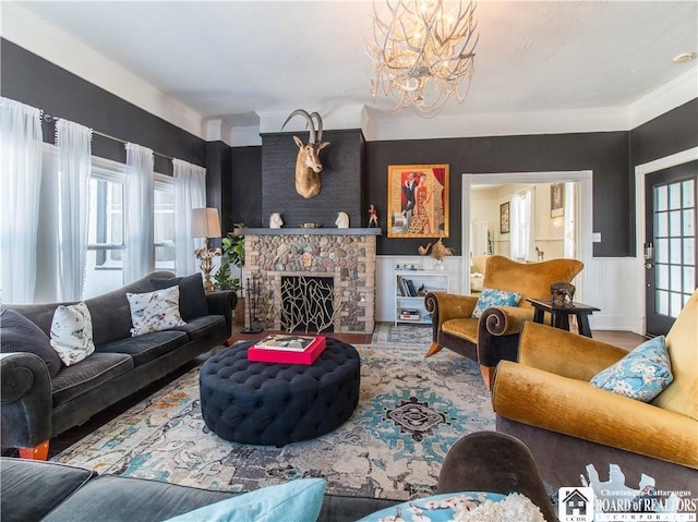 living room with an inviting chandelier, hardwood / wood-style floors, and a fireplace