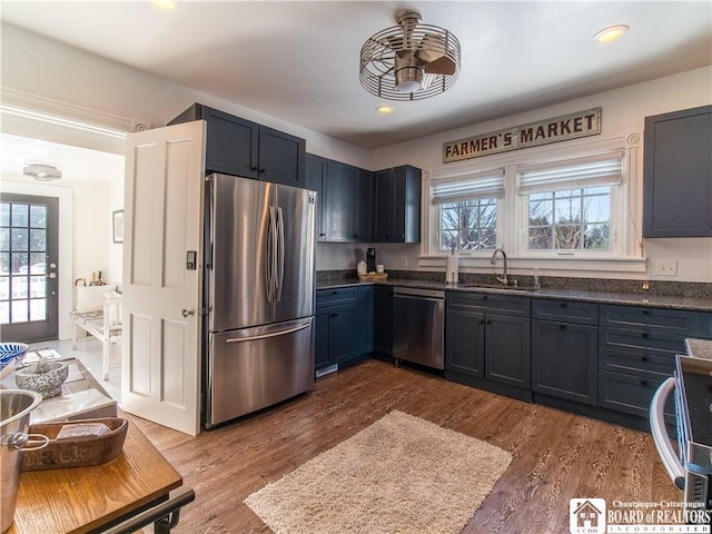 kitchen with stainless steel appliances, a healthy amount of sunlight, sink, and dark hardwood / wood-style floors