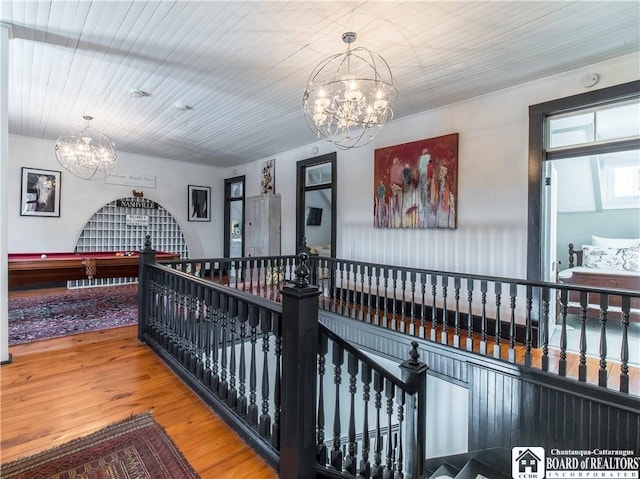 bedroom featuring wood-type flooring and a notable chandelier