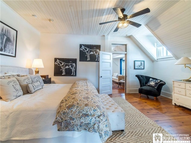 bedroom featuring hardwood / wood-style flooring, vaulted ceiling, wooden ceiling, and ceiling fan