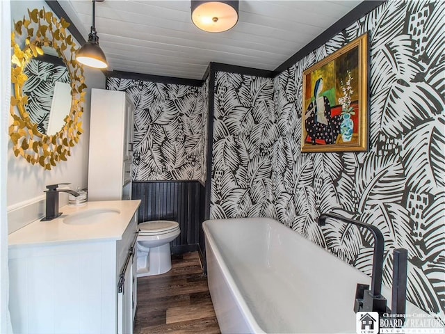 bathroom featuring toilet, wooden ceiling, vanity, a tub, and hardwood / wood-style floors