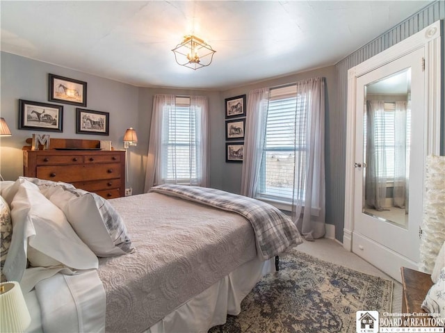 bedroom featuring multiple windows and carpet flooring