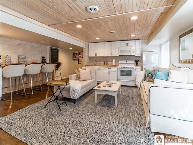 living room with wood ceiling, dark wood-type flooring, and indoor bar