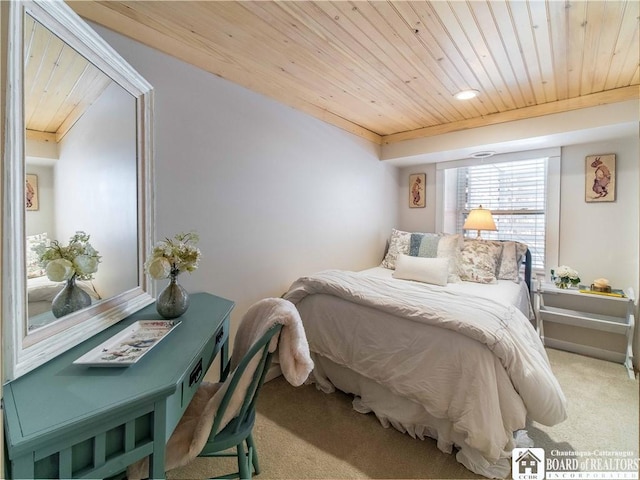 bedroom with wood ceiling and carpet flooring