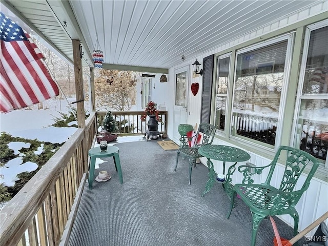 view of snow covered back of property