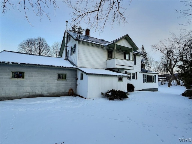 snow covered property featuring a balcony