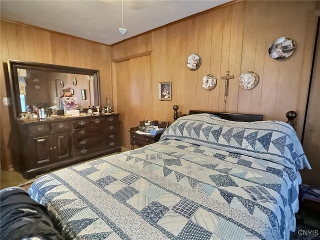 bedroom featuring wooden walls and a closet