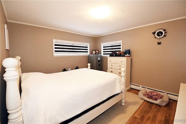 bedroom featuring ornamental molding, hardwood / wood-style floors, and baseboard heating