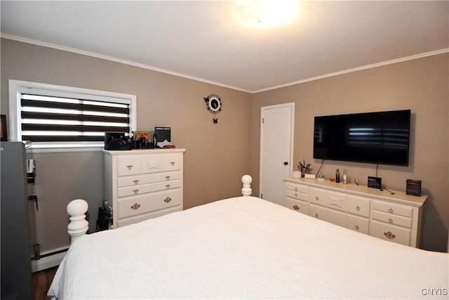 bedroom with ornamental molding and a baseboard heating unit