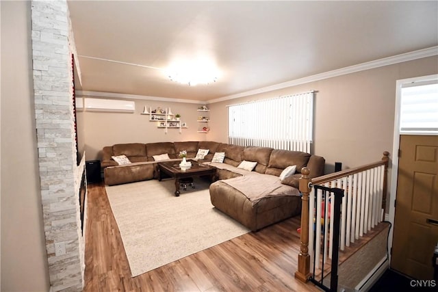 living room featuring hardwood / wood-style floors, crown molding, and a wall mounted air conditioner