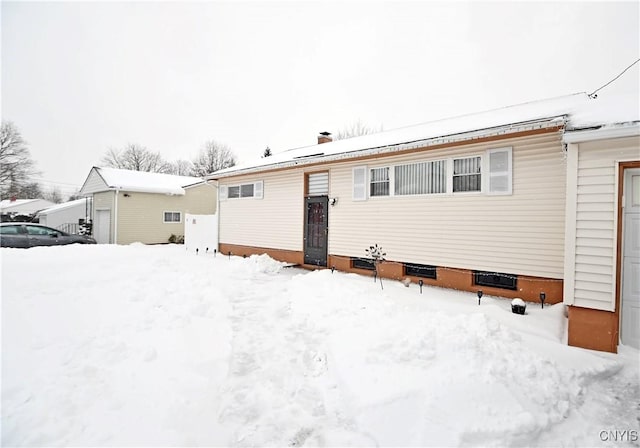 snow covered property featuring a garage