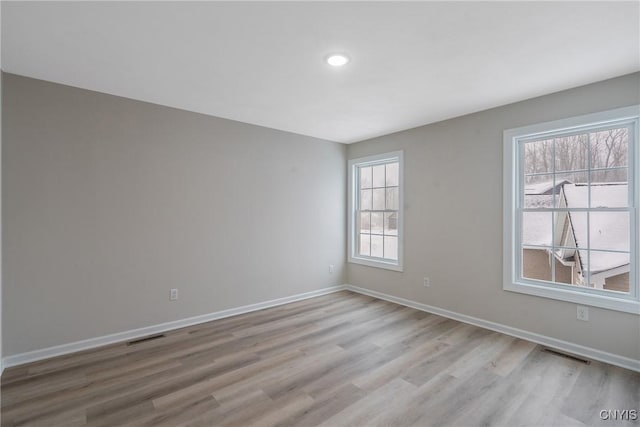 spare room featuring light hardwood / wood-style floors