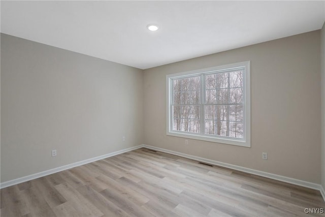 spare room with light hardwood / wood-style flooring