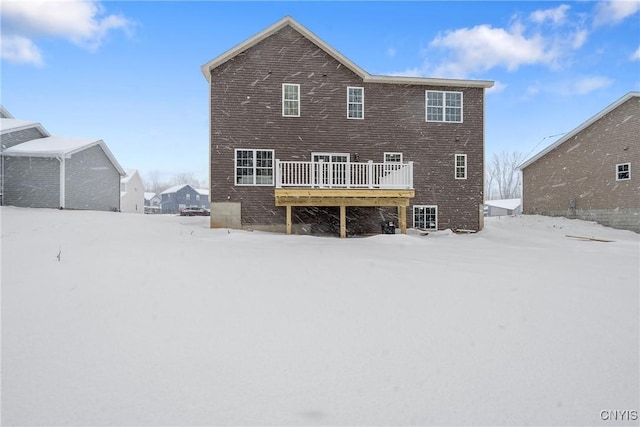 snow covered property featuring a deck