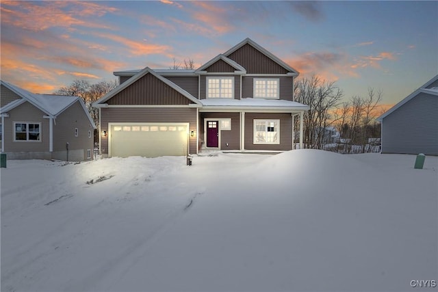 craftsman inspired home with a garage and covered porch