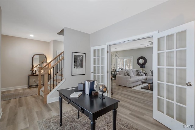 home office featuring french doors, ceiling fan, and light hardwood / wood-style flooring