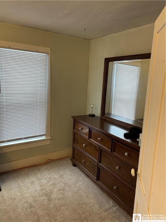 bedroom featuring light colored carpet