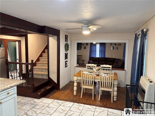 dining space featuring heating unit and ceiling fan