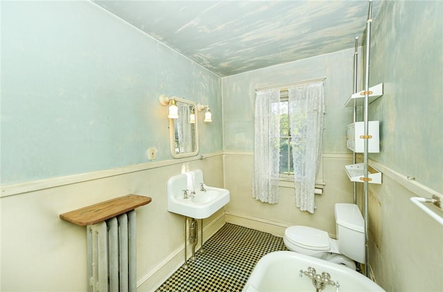 bathroom with radiator heating unit and toilet