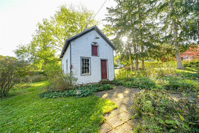 view of outbuilding with a lawn