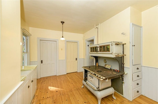 kitchen featuring white cabinetry, pendant lighting, and light wood-type flooring