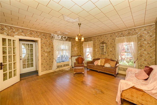 unfurnished room with crown molding, hardwood / wood-style floors, and french doors