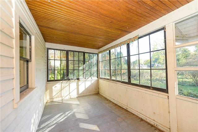 unfurnished sunroom with wooden ceiling