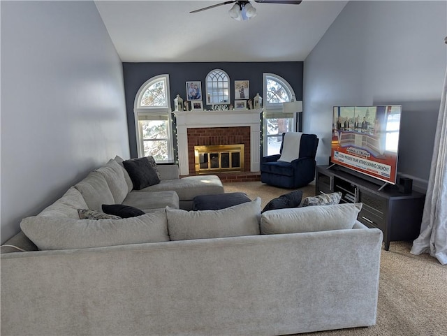 carpeted living room featuring ceiling fan, lofted ceiling, and a fireplace