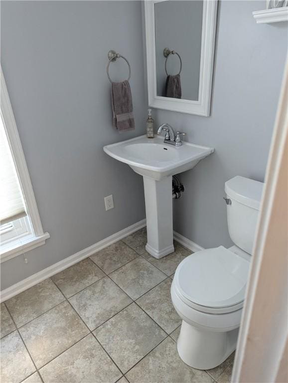 bathroom with tile patterned floors, toilet, and sink