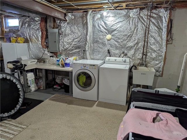 clothes washing area with electric panel, sink, and washer and clothes dryer