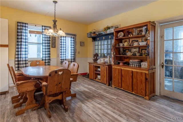 dining area with a chandelier and light wood-type flooring