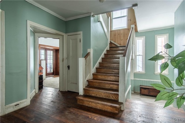 staircase with hardwood / wood-style floors and ornamental molding