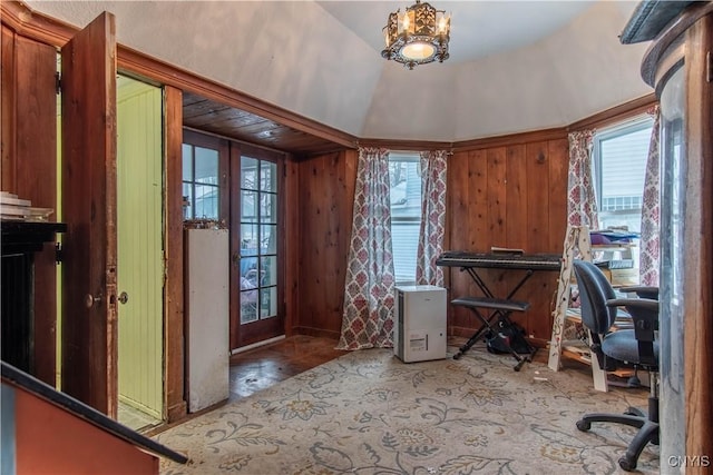 interior space with plenty of natural light, french doors, and wooden walls