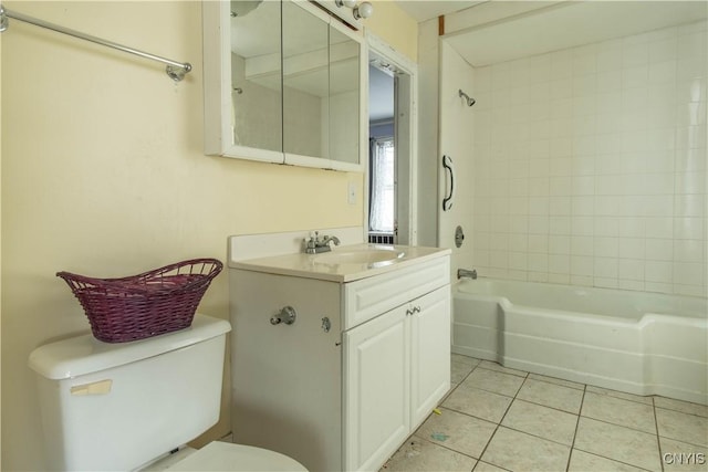 full bathroom featuring vanity, tiled shower / bath combo, tile patterned floors, and toilet