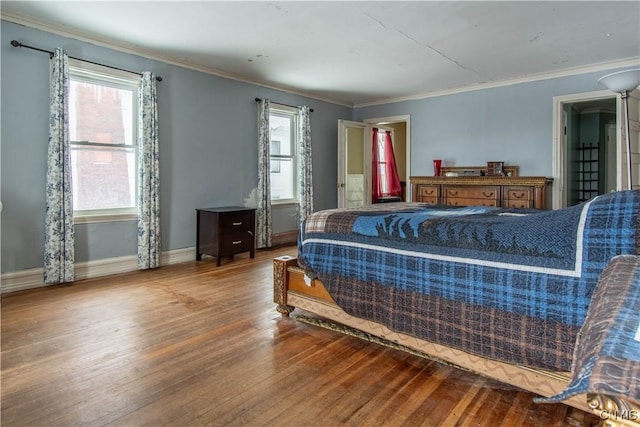 bedroom with hardwood / wood-style floors and ornamental molding