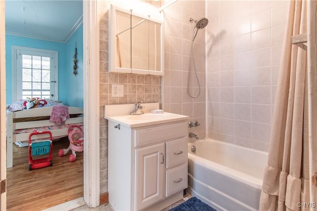 bathroom with crown molding, tile walls, vanity, shower / bath combo with shower curtain, and hardwood / wood-style flooring