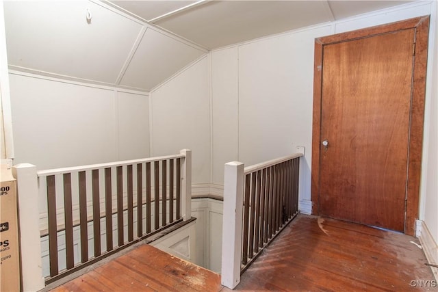 hallway featuring dark wood-type flooring and lofted ceiling